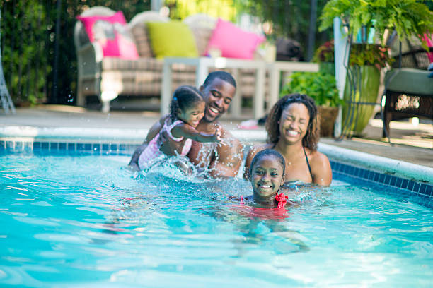 Swimming Family having fun in their pool. scuba diving family stock pictures, royalty-free photos & images