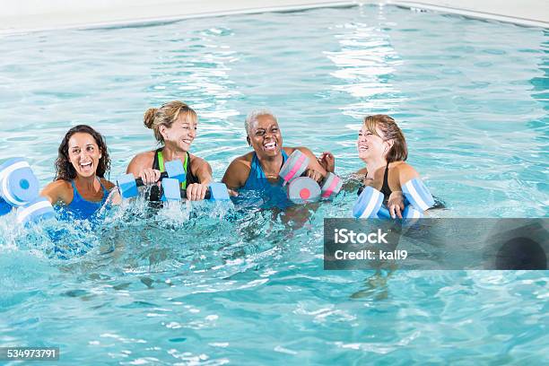 Group Of Women In Water Aerobics Exercise Class Stock Photo - Download Image Now - Swimming, Swimming Pool, Water Aerobics