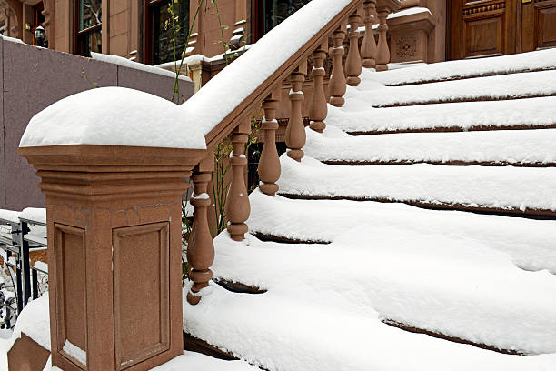 istock Snow covered staircase on Brownstone apartment building 534976853