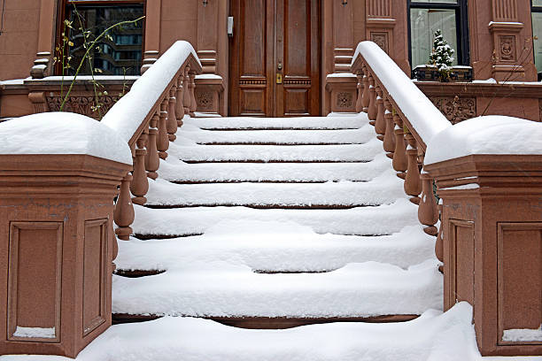 Snow covered staircase on Brownstone apartment building