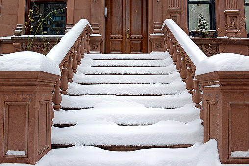 Snow covered staircase on Brownstone apartment building, Upper West Side, New York City