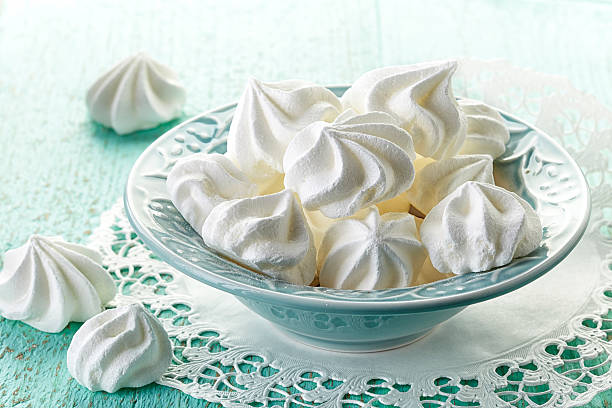 bowl of meringue cookies meringue cookies in blue bowl meringue stock pictures, royalty-free photos & images