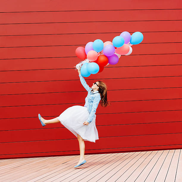 istock Running girl with colorful balloons 534978033