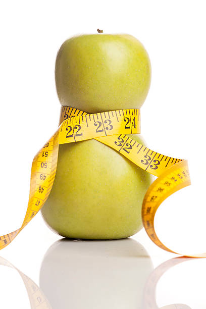 istock Concept for a diet. Apple wrapped in measuring tape 535003345