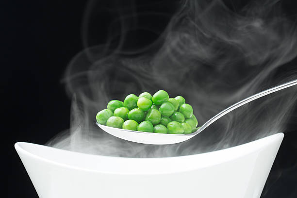 istock spoon with hot peas from which emits smoke 535006099