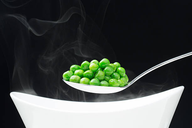istock spoon with hot peas from which emits smoke 535006107