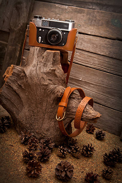 istock brown leather belt and retro camera on wooden background 535009625