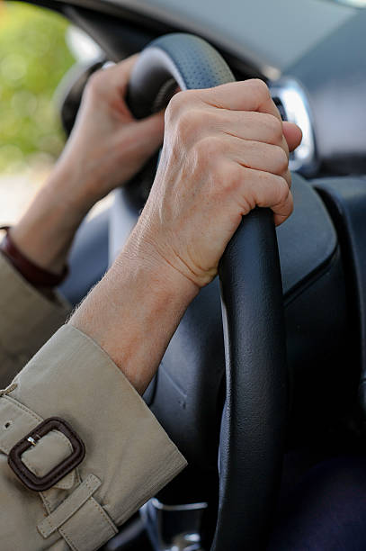 istock Senior woman hand on steering wheel 535011041