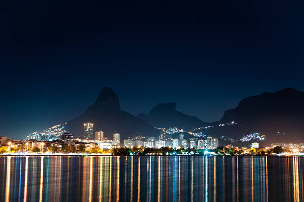 Rio de Janeiro at Night Nice Night View of Mountains and City Lights of Rio de Janeiro near Rodrigo de Freitas Lagoon. two brothers mountain stock pictures, royalty-free photos & images