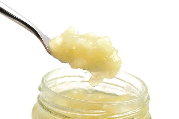 Apple sauce scooped out of a jar.