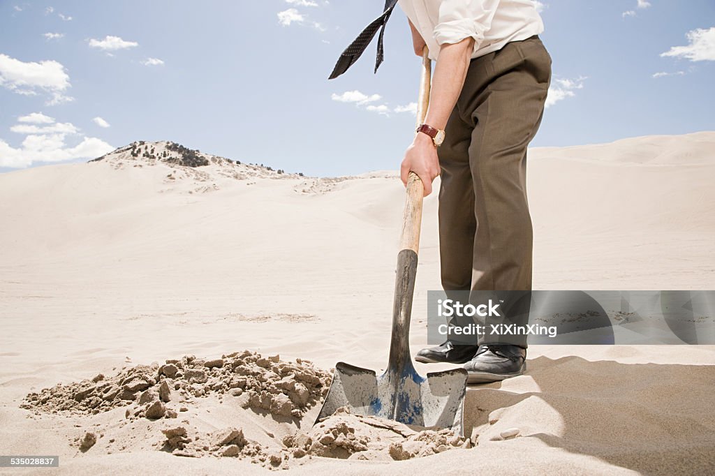 Man digging in desert Treasure Chest Stock Photo