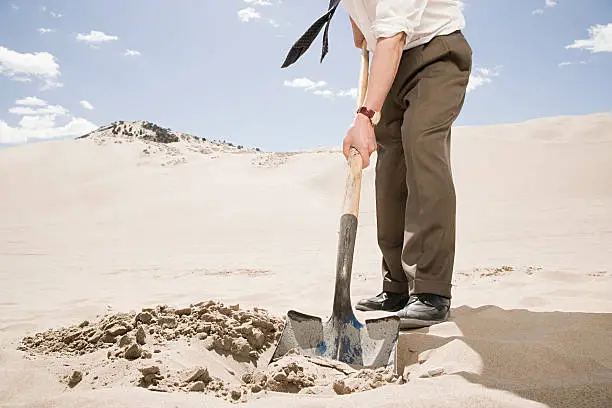 Man digging in desert