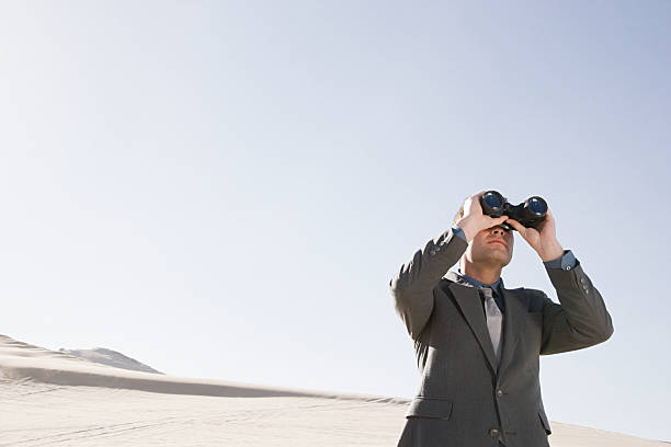 istock Businessman in desert with binoculars 535028871