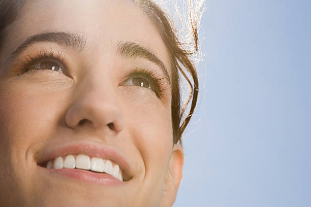 Face of a woman in sunlight Face of a woman in sunlight light at the end of the tunnel stock pictures, royalty-free photos & images