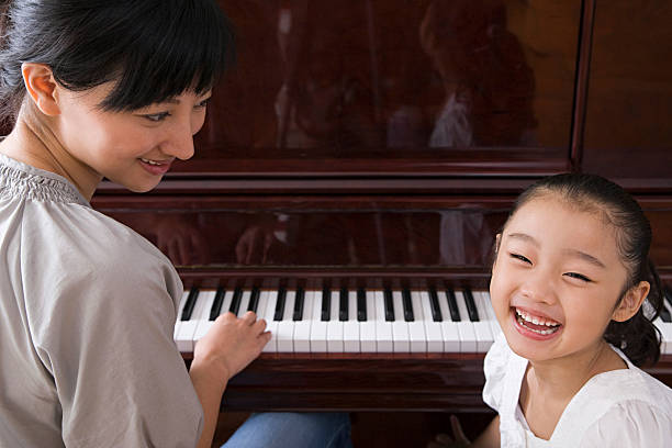 istock Mother playing the piano for her daughter 535028917