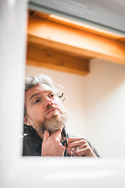 istock cutting the beard in front of mirror 535029165