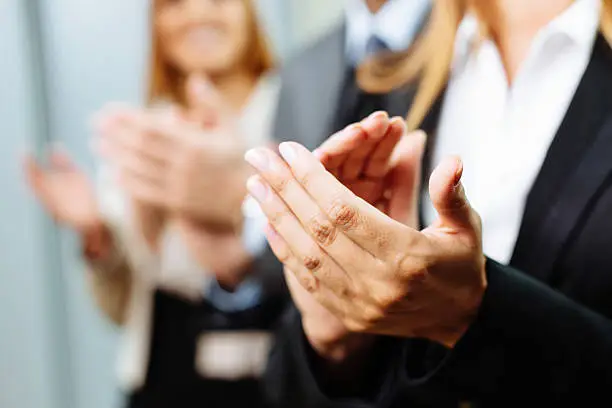 Close-up of business people clapping hands. Business seminar concept