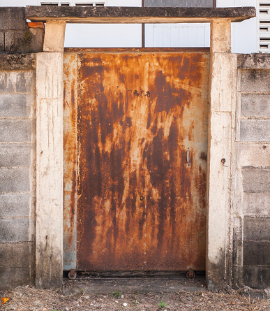 old metal sliding door with rusty, at a fence