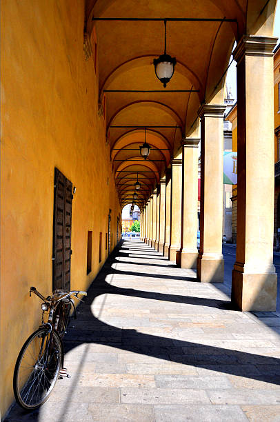 bike, shadows and contrasts in a deep perspective typical italian porch