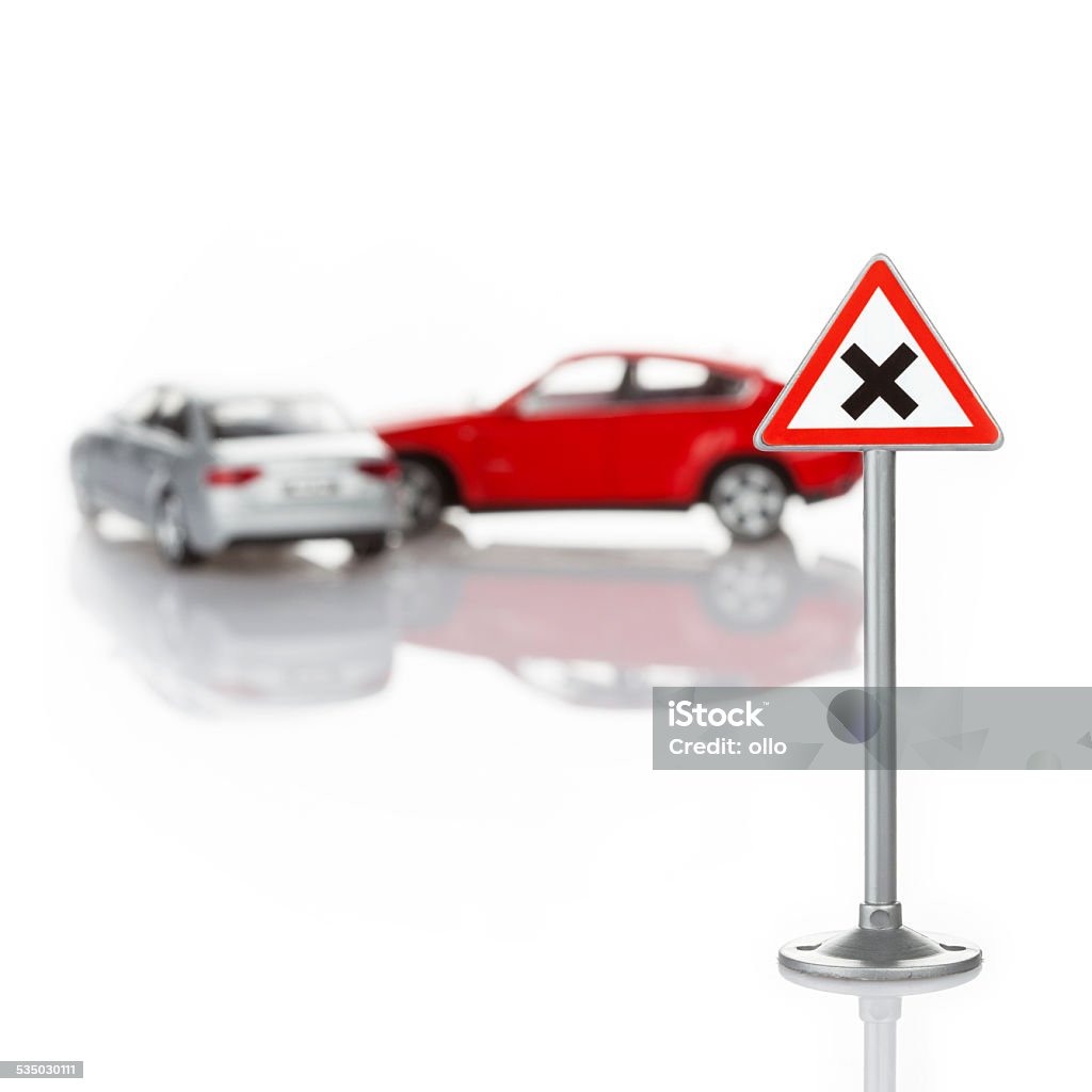 Toy road sign and unrecognisable defocused cars - accident Toy road sign and defocused cars - Right has right-of-way, accident. Concept of traffic regulation and/or offense 2015 Stock Photo