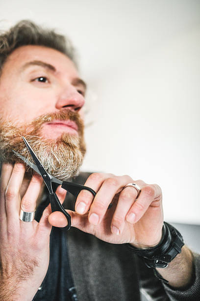 istock cutting the beard in front of mirror 535030315