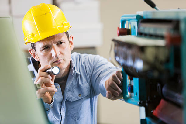 istock Man working in printing plant inspecting machine 535040699
