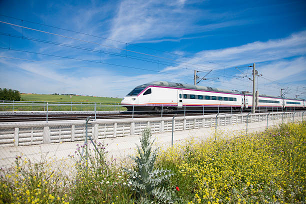 fast train fast speed train over flowers in a landscape from Spain high speed train photos stock pictures, royalty-free photos & images