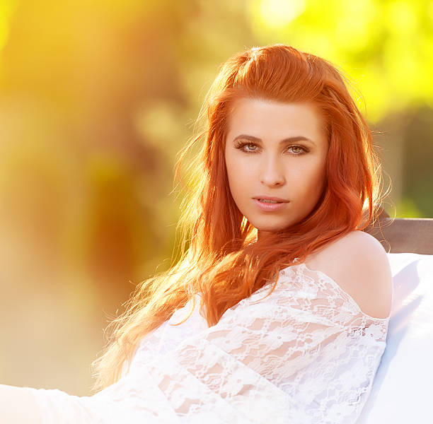 red hair woman in park portrait.