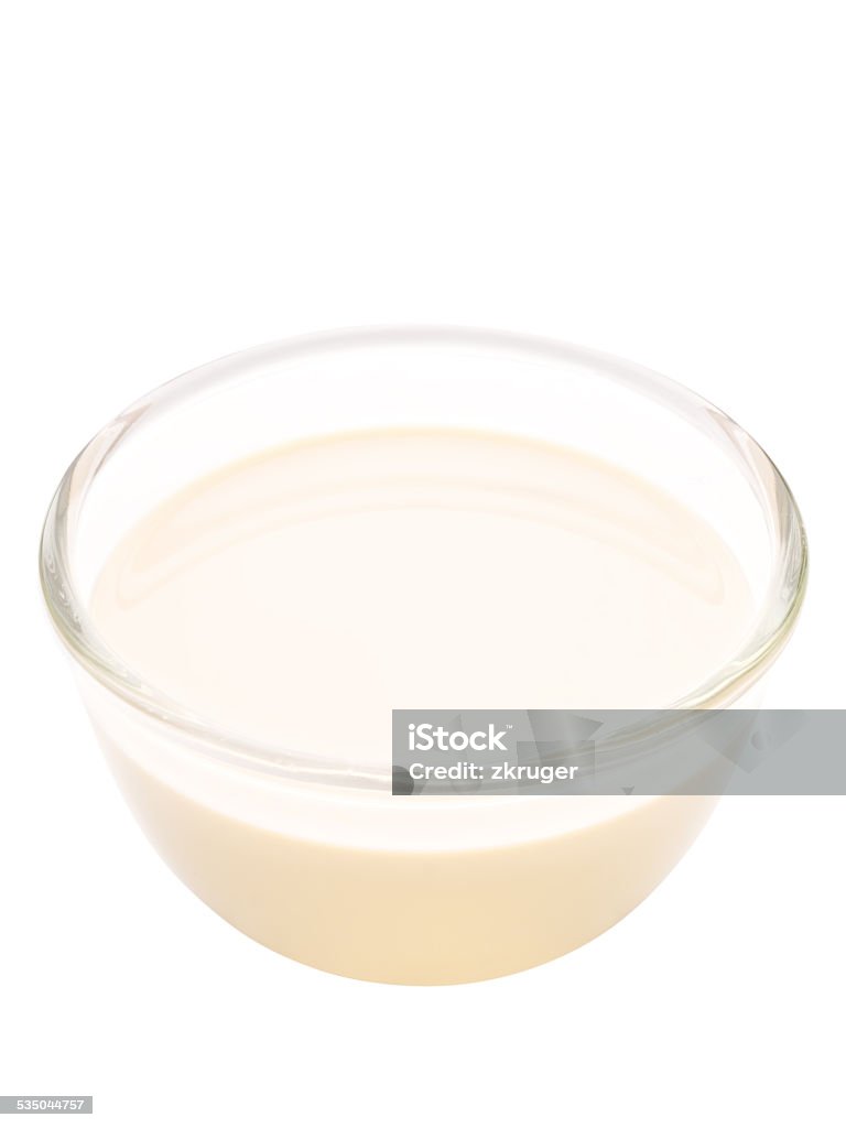 bowl of evaporated milk isolated close up of a bowl of evaporated milk isolated Condensed Milk Stock Photo