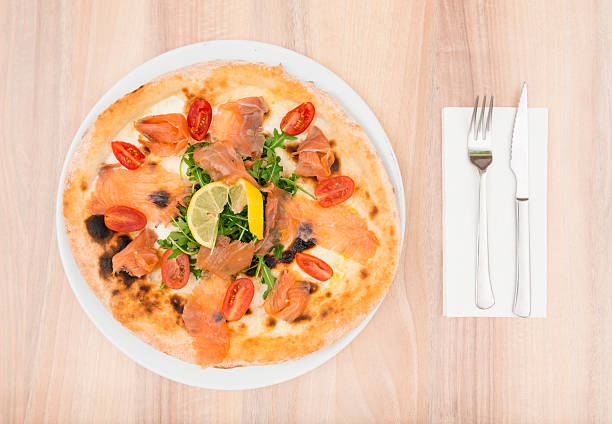 Delicious Italian pizza with smoked salmon shot from directly above. Copy space on right.