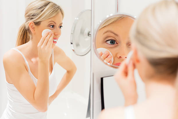 istock Young woman removing makeup 535045173
