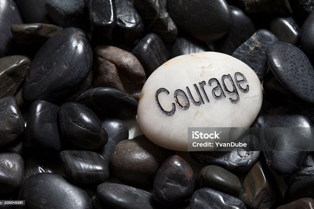 courage Inspirational stone Close up of engraved stone courage 2015 Stock Photo