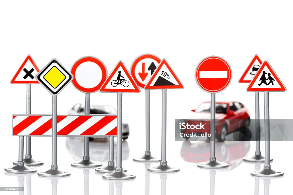 Toy road signs and unrecognisable defocused cars Toy road signs and unrecognisable defocused cars - concept of traffic regulations 2015 Stock Photo