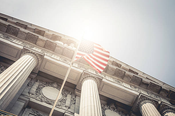 San Francisco City Hall entrance seen from below with a national flag.
