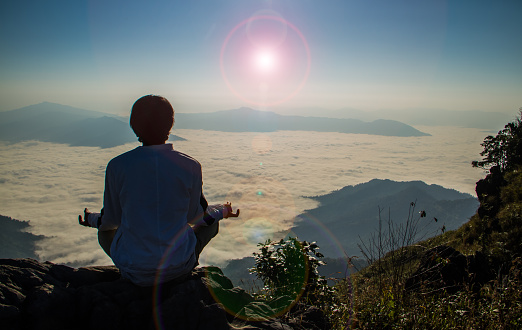 Meditation on  top of the mountain when sunrise.