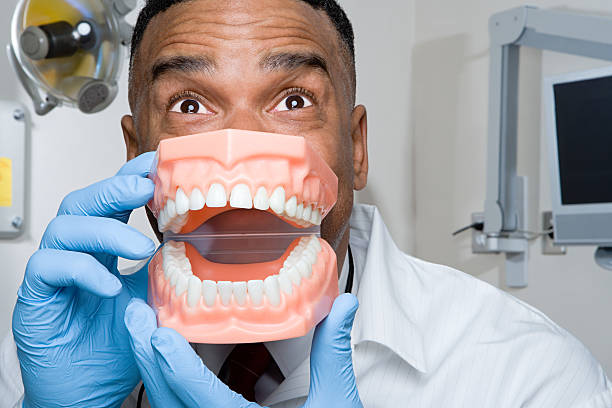 Dentist Holding False Teeth Stock Photo - Download Image Now - Dentist, Humor, Dentist's Office - iStock Dentist Holding False Teeth Stock Photo - Download Image Now - Dentist, Humor, Dentist's Office - iStock
