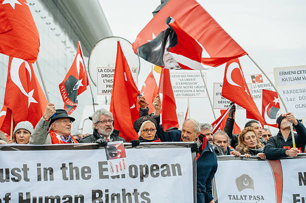 Armenian and Turkey diaspora protesting Strasbourg, France - January 28, 2015: Turkey diaspora demonstrates near European Court of HR before the Perincek vs. Switzerland case begin. Armenian government was represented by Amal Clooney european court of human rights stock pictures, royalty-free photos & images