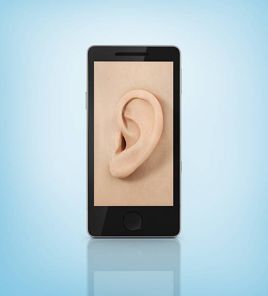 istock Ear to the phone screen. Listen concept. 535076069