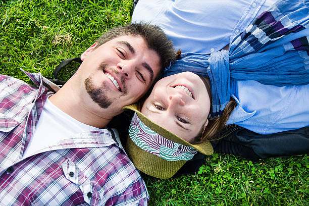 istock Couple lying on the grass in a park 535077549