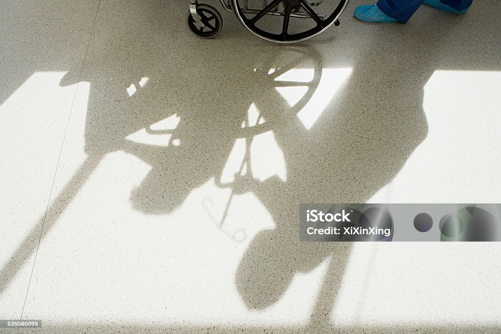 Nurse pushing patient in wheelchair Corridor Stock Photo