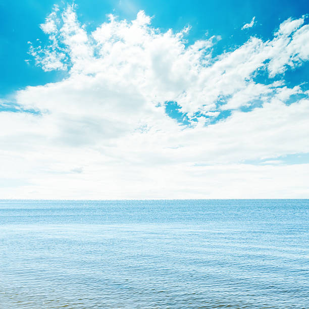 istock blue sea and white clouds in sky over it 535106395