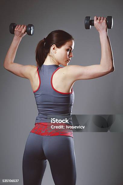 Dumbbell Exercise Stock Photo - Download Image Now - 20-24 Years, 20-29 Years, 2015