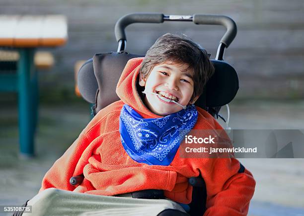 Handsome Happy Biracial Eight Year Old Boy Smiling In Wheelchair Stock Photo - Download Image Now