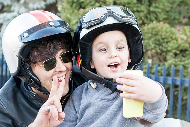 istock father and son motorcyclists take a selfie on the road 535110613