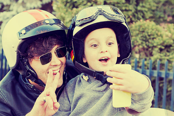 istock father and son motorcyclists take a selfie on the road 535110615