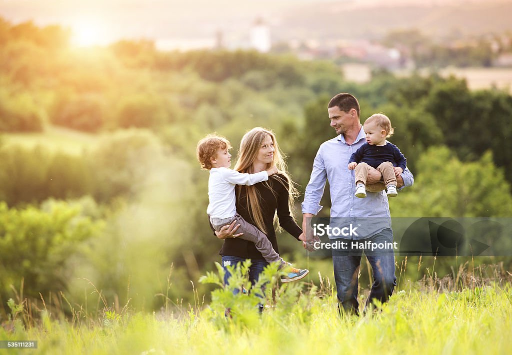 Happy family Happy young family spending time together outside in green nature. Family Stock Photo