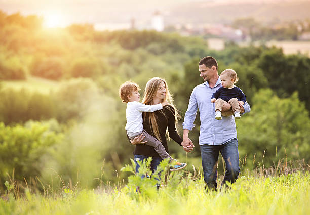 Happy family Happy young family spending time together outside in green nature. young family stock pictures, royalty-free photos & images