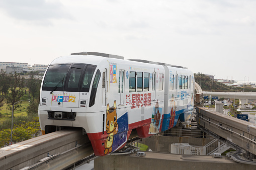 Naha, Japan - January 30, 2015 : Okinawa Monorail move past the Naha Airport Station in Naha, Okinawa, Japan. It is the only public rail system in Okinawa Prefecture.