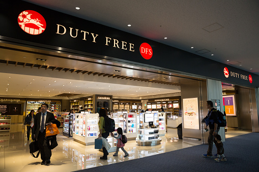 Naha, Japan - January 30, 2015 : People at the Duty Free Shop at Naha Airport in Okinawa, Japan. It offers a wide range of items, such as beauty, watches & jewelry, sunglasses and wines.