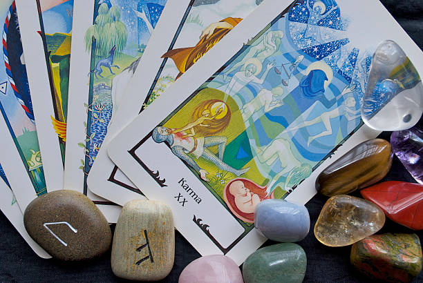 Karma Tarot Card , Runes & Crystals Nelson, NZ - November 4, 2008: Karma Tarot Card  from the Tarot of the Old Path Deck published in 1990 by Swiss AG Müller. This card signifies cause and effect or 'Reaping what you sow'. It is shown with other Fortune Telling paraphernalia such as Runes and Gemstone Crystals. runes photos stock pictures, royalty-free photos & images